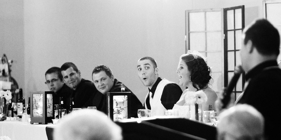 Wedding photographer captures a groom reacting to his brother's speech at St George Banquet Hall in Waterloo, Ontario