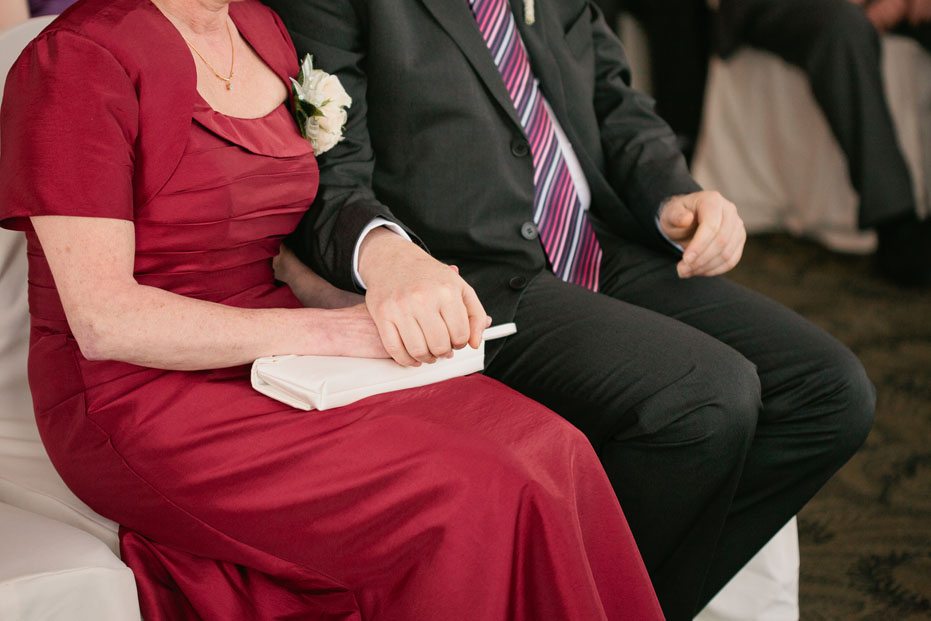 mom and dad holds hands at a wedding in Ingersoll, Ontario