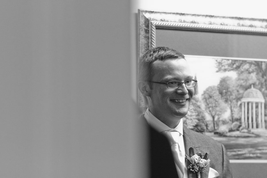 the excited groom waits for his bride on their wedding day at Elm Hurst Inn in Ingersoll, Ontario