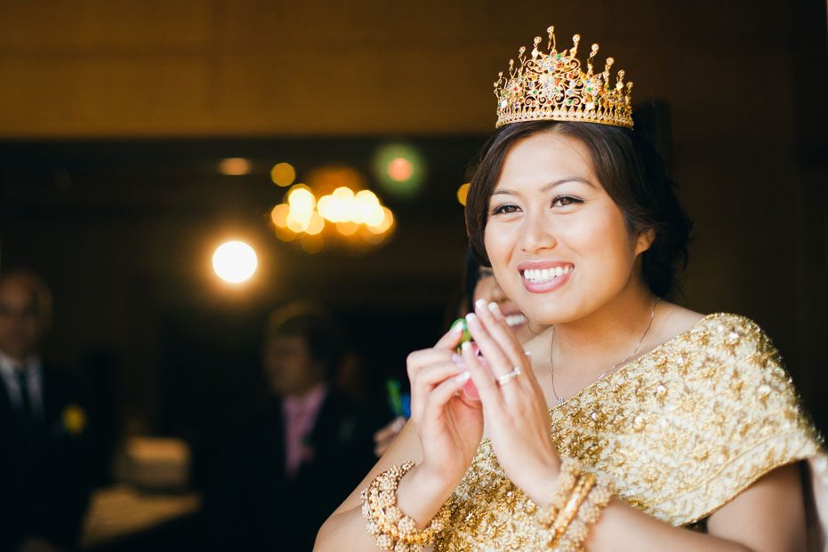 a beautiful Cambodian bride in Kitchener-Waterloo greets guests as they come in at a wedding in Kitchener, Ontario