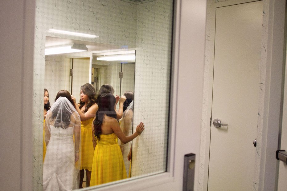 the bride and her bridesmaids get ready before the ceremony as captured by Kitchener wedding photojournalist