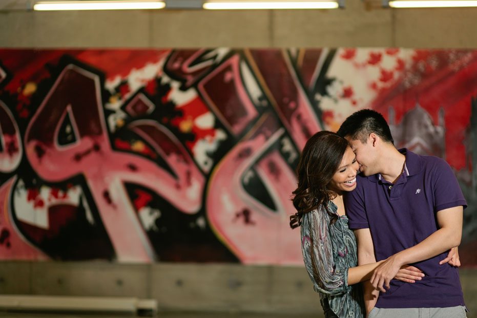 a graffiti as a background during an engagement session in Mississauga, Ontario