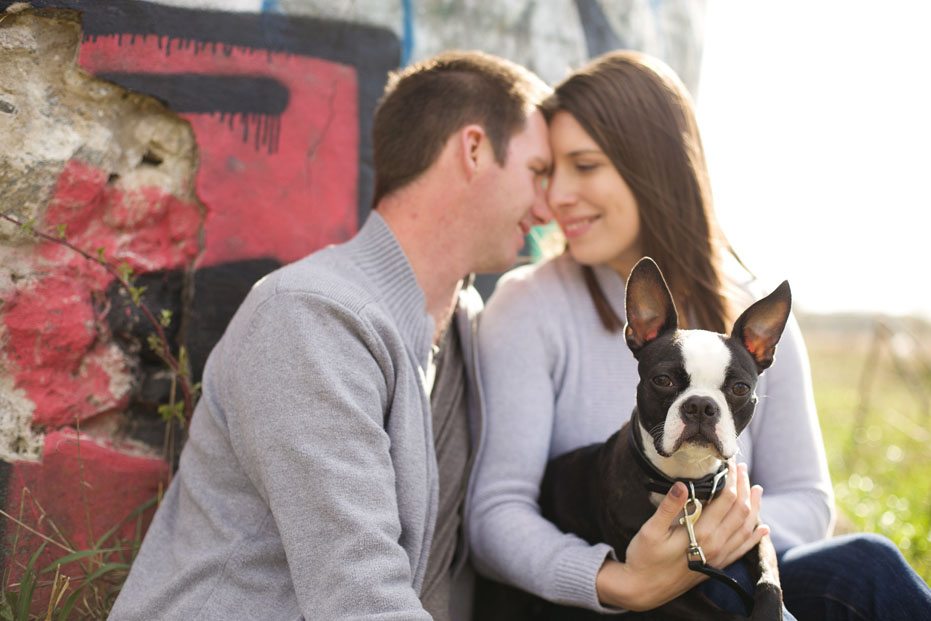 a cute portrait of an engaged people with their dog